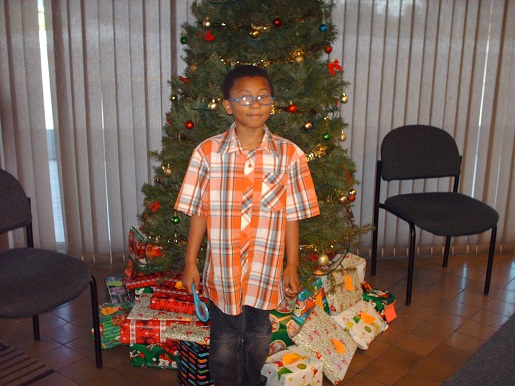 A boy standing in front of the Christmas Tree